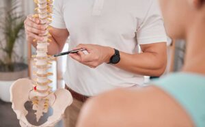 Athlete receiving a careful back adjustment in a bright clinical treatment room